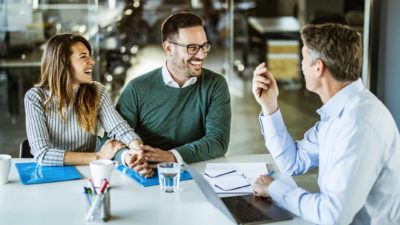 couple happily discussing their issues with a banker