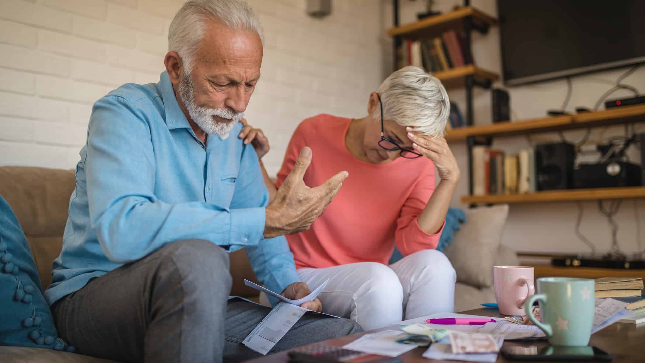 senior couple disappointed and sad at their financial situation