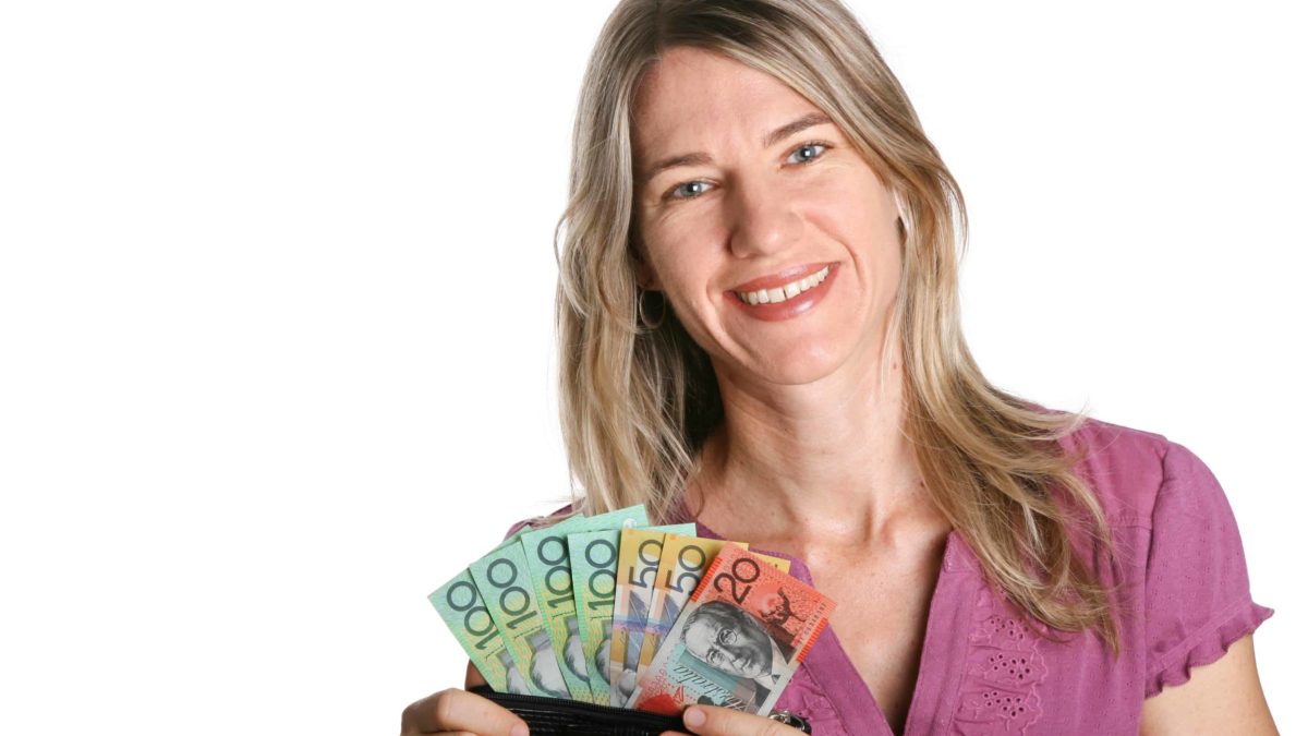 woman holding Australian money and happy with the dividends she has gotten