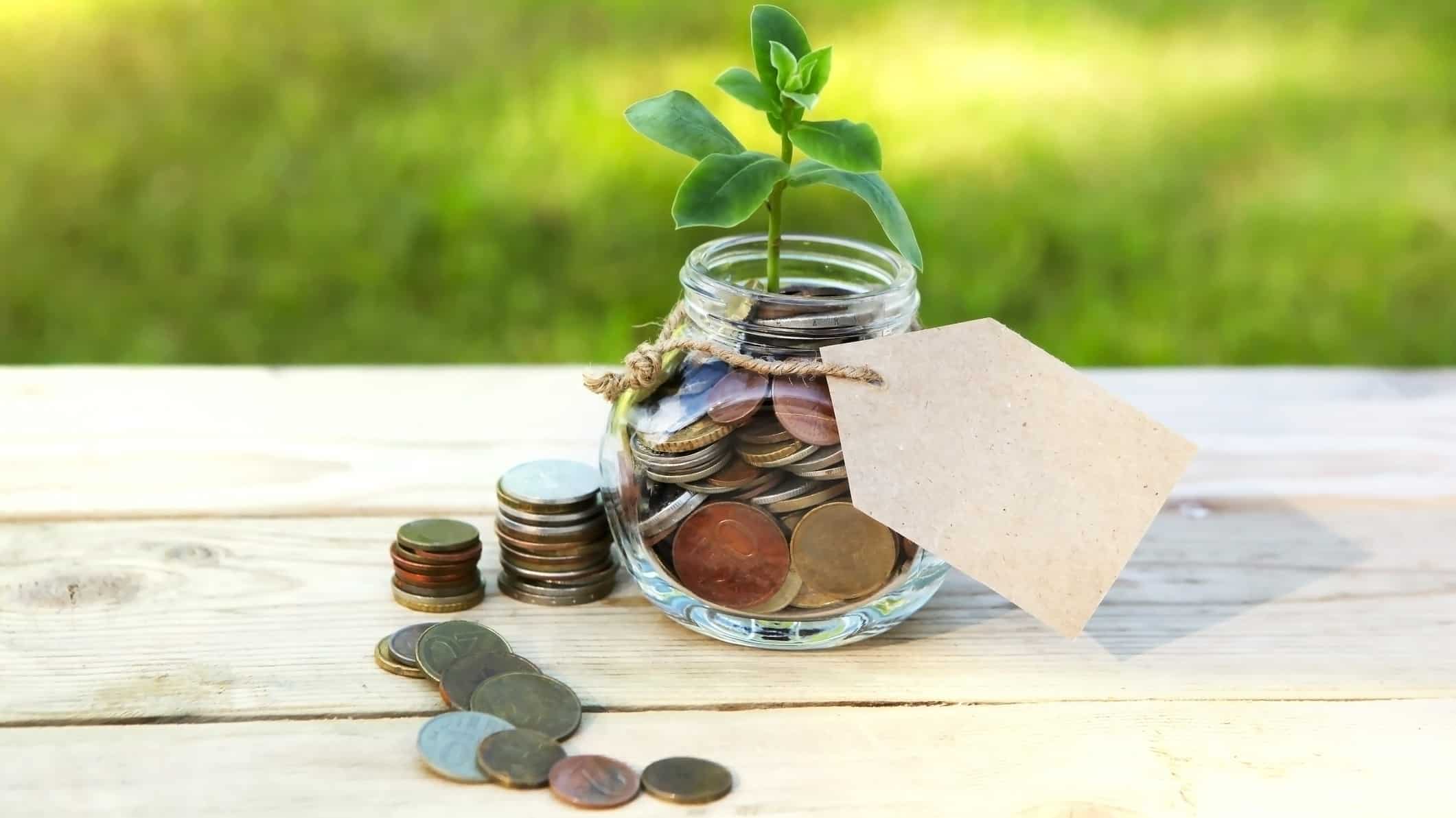 A money jar filled with coins, indicating an investment return from an ASX dividend share