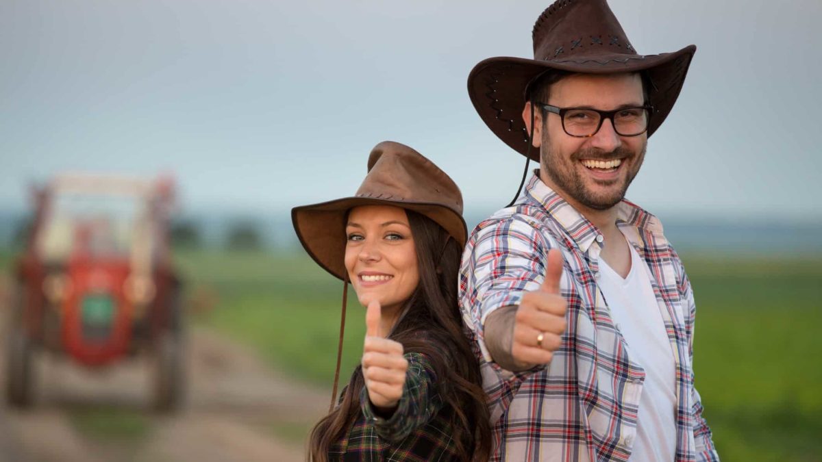 happy farming couple both with their thumbs up
