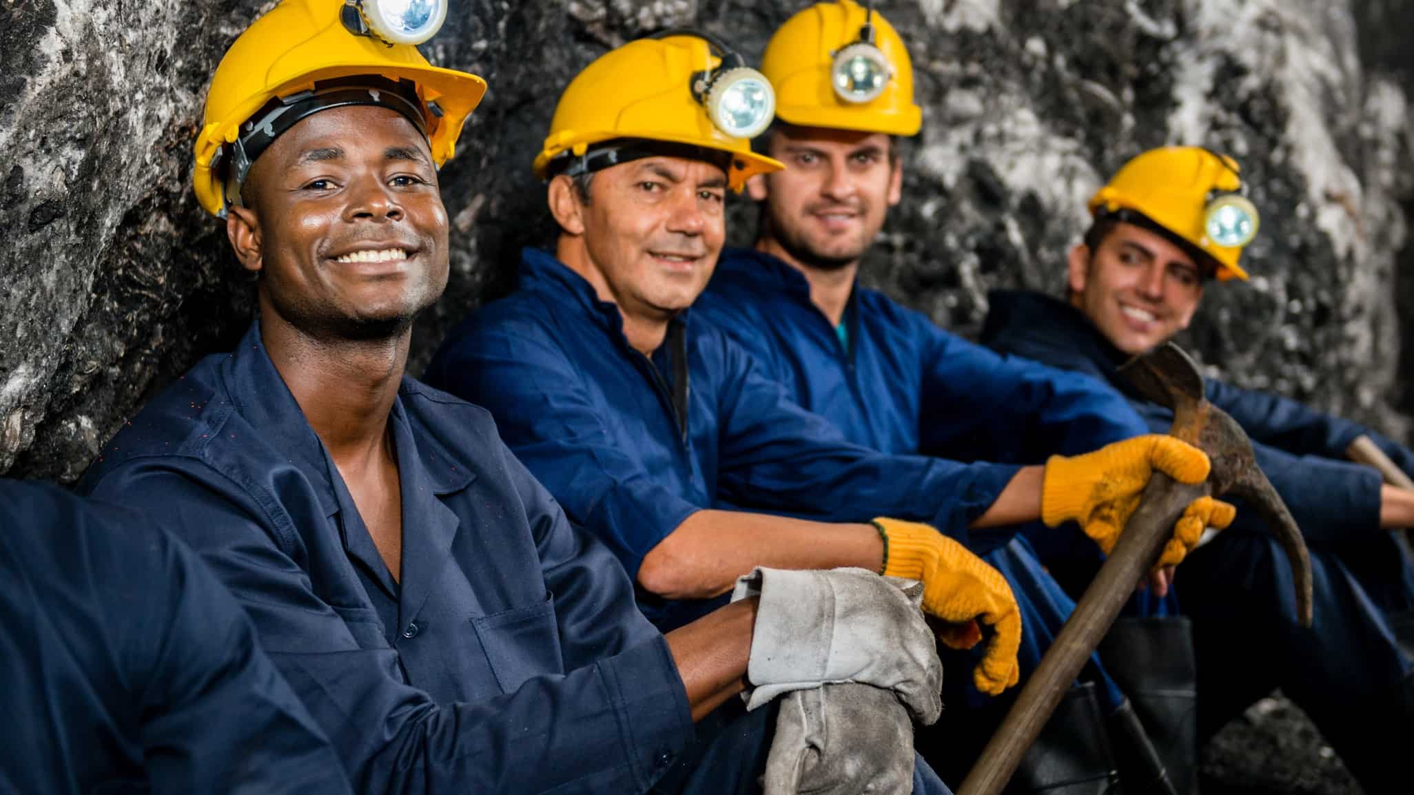 happy looking men working at a mine, indicating a share price rise for ASX resource shares
