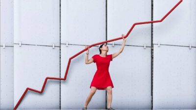woman holding up a rising red graph