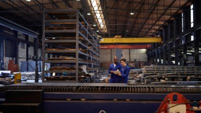 male and female workers at a steel factory