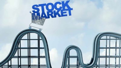 the word stock market in a trolley on a roller coaster track symbolising volatility