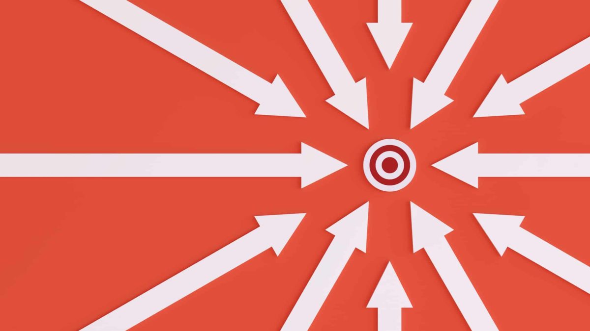 A target on a red background surrounded by white arrows pointing to it, indicated share price rises on or exceeding their target