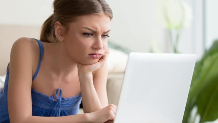 unhappy and irritated women using her macbook