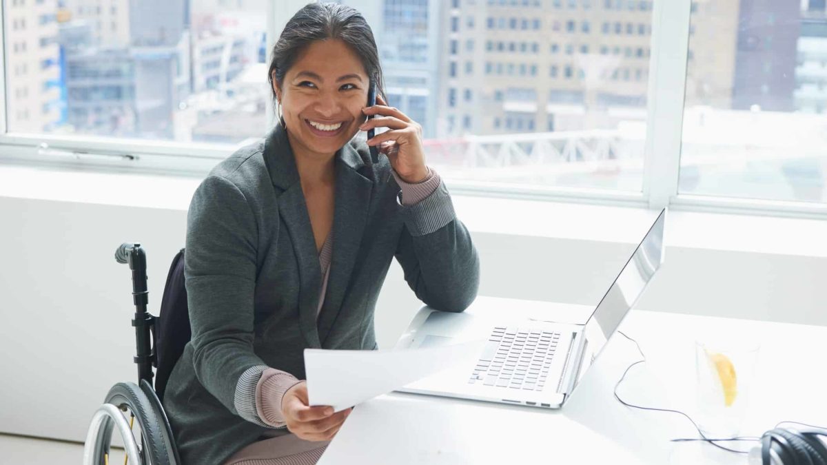 woman in wheelchair at desk