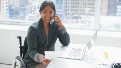 woman in wheelchair at desk