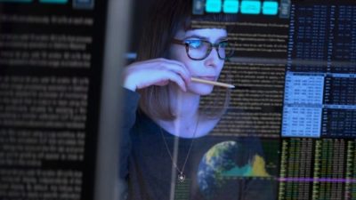 women with a pencil in her hand looking at a screen