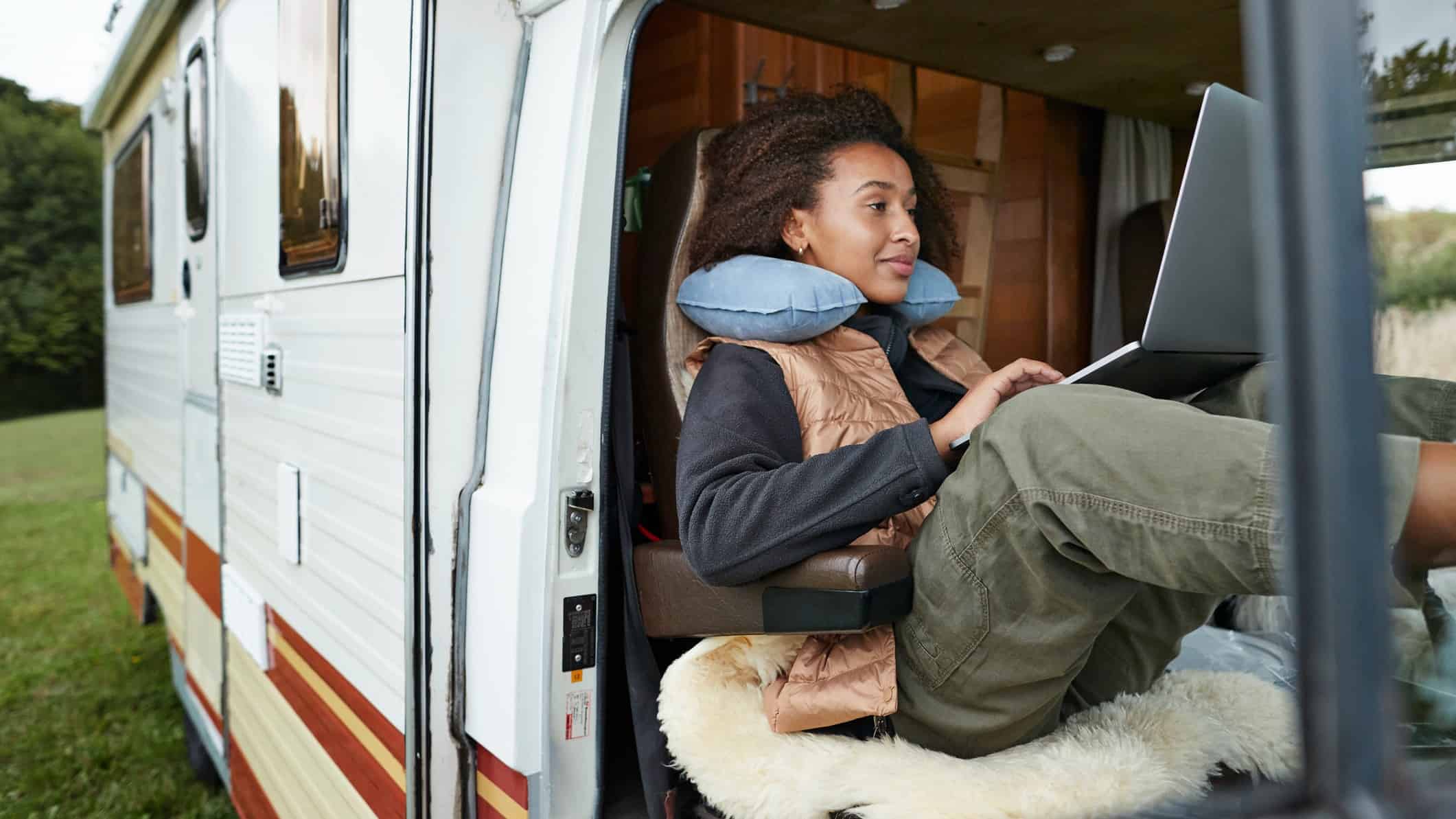 woman using laptop in campervan