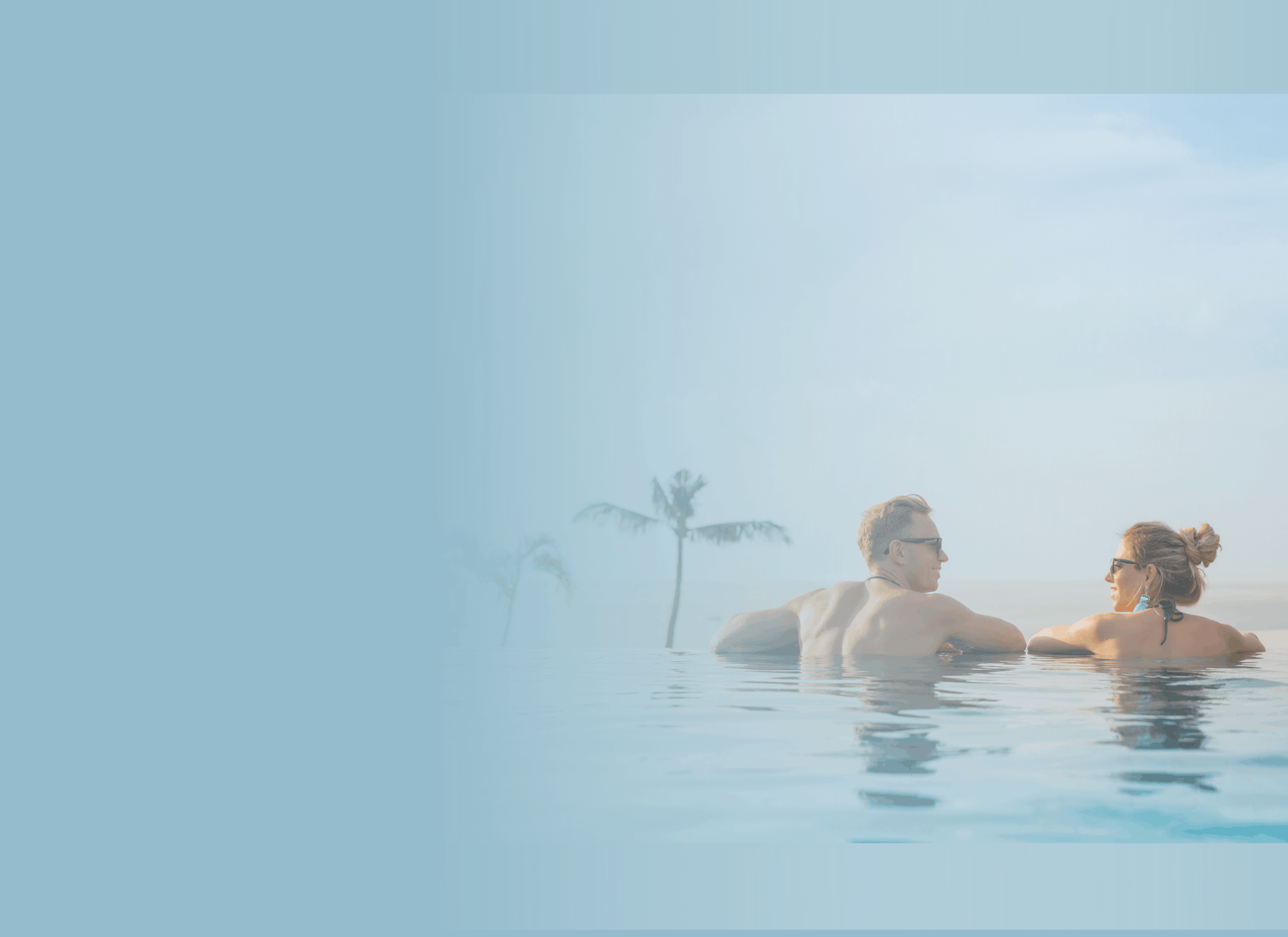 couple talking while in an infinity pool