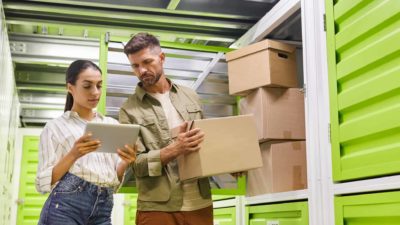 Couple pack boxes at self storage unit