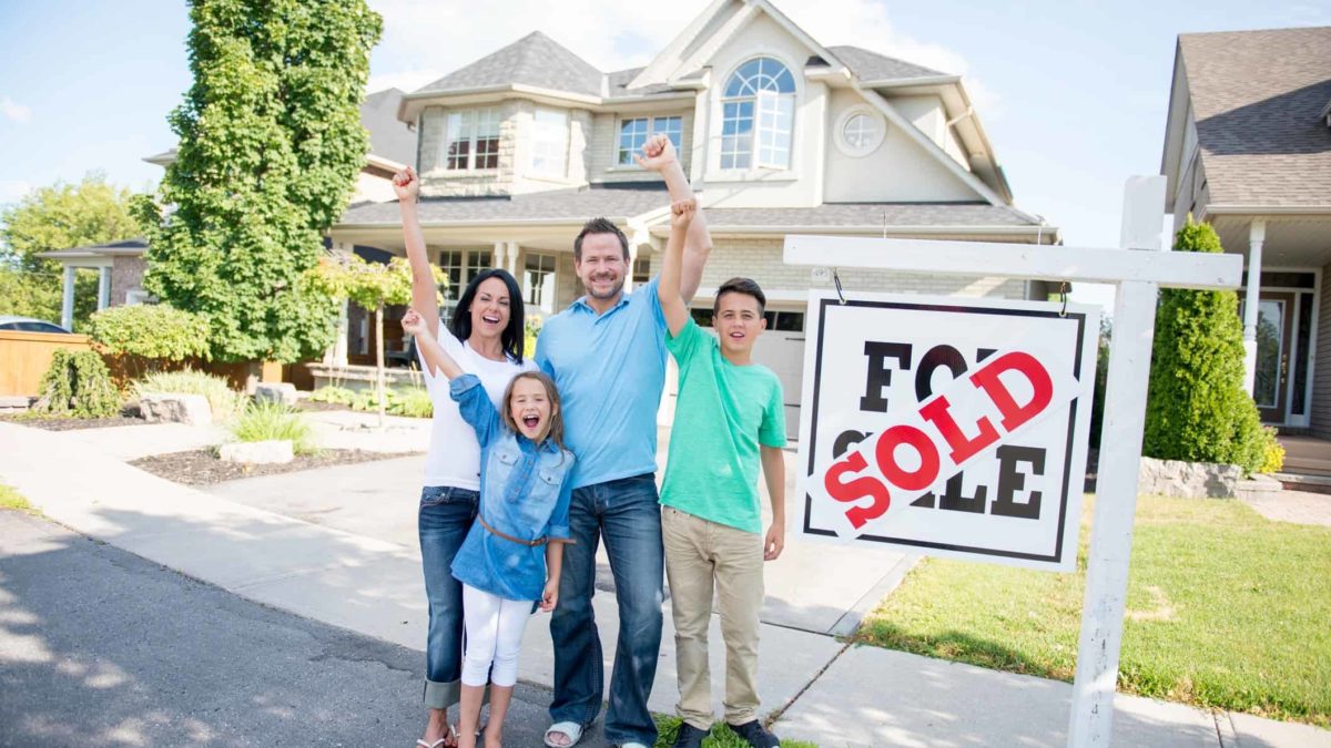 Family celebrates buying new house