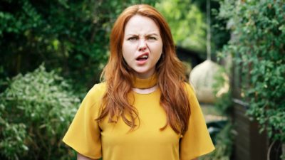 A woman faces the camera with her lip raised up to the side in total confusion.