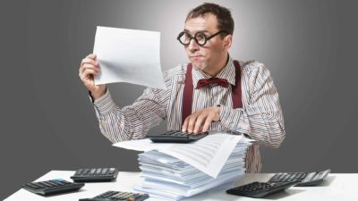 comical investor reading documents and surrounded by calculators