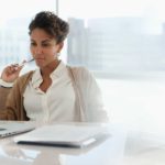 thoughtful investor sitting at computer