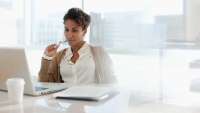 thoughtful investor sitting at computer