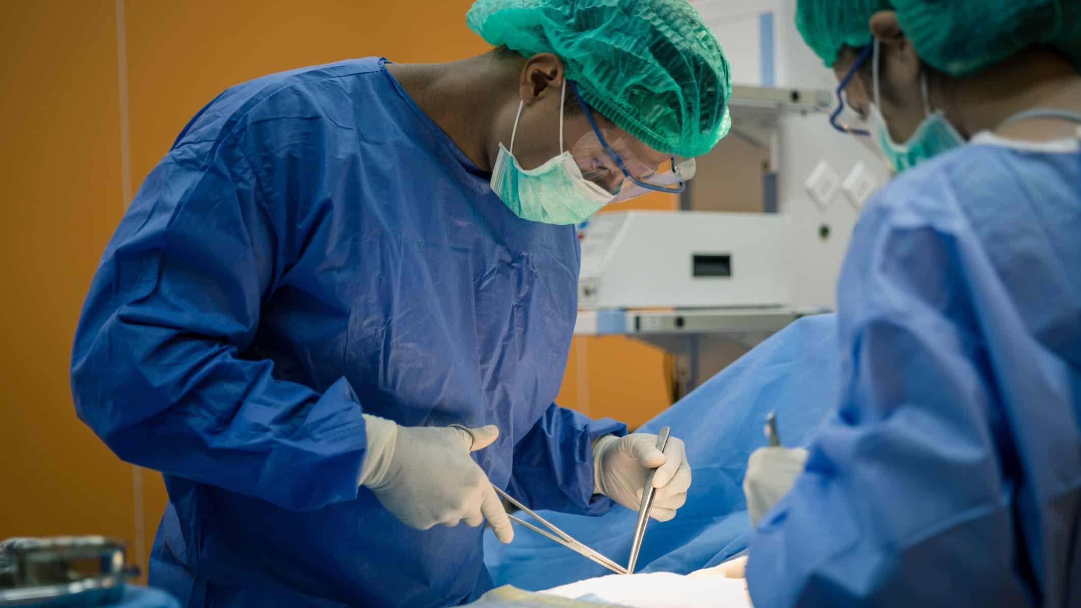medical doctor performing surgery using surgical instruments
