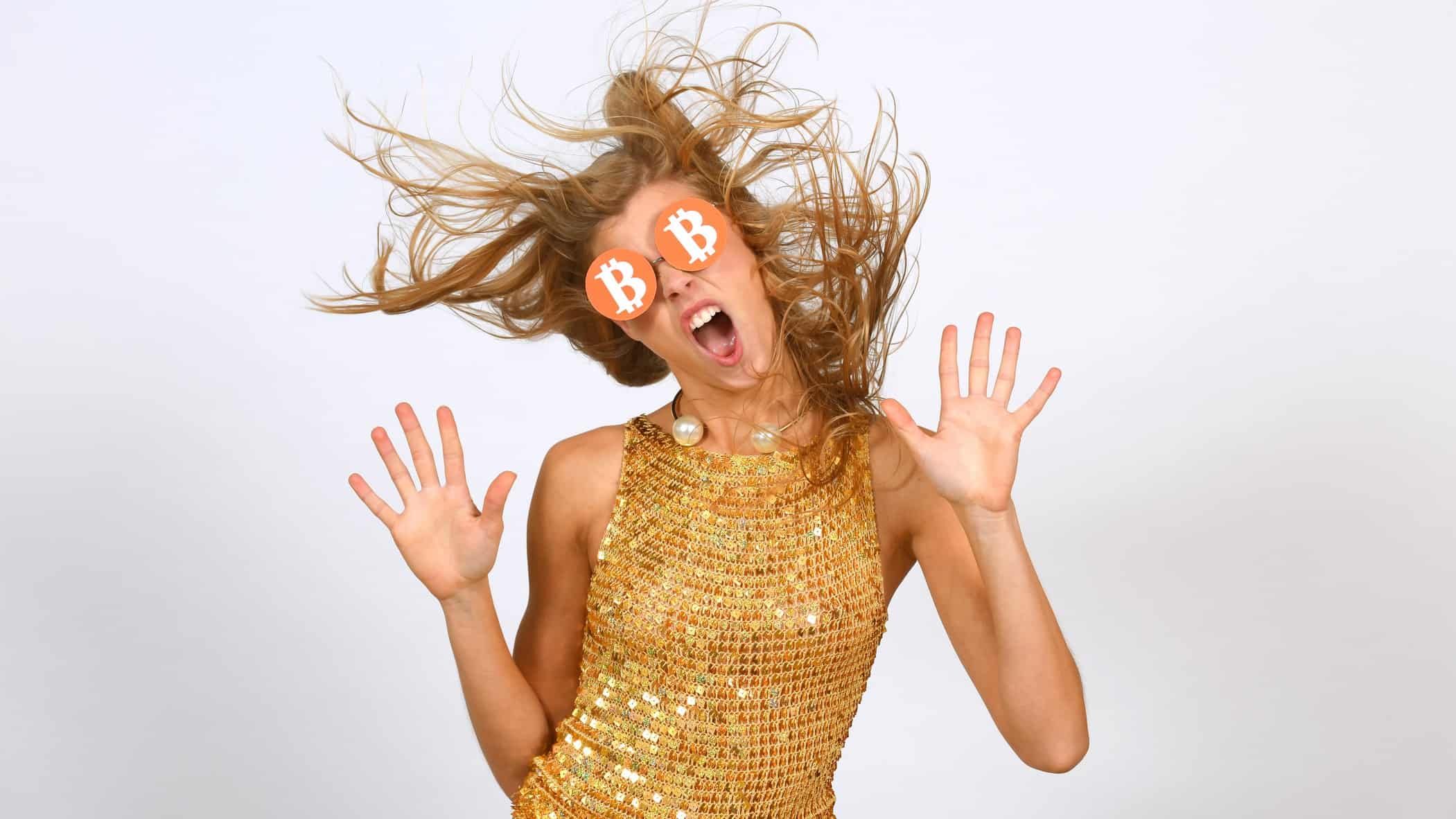 person dancing in bitcoin spectacles wearing a gold outfit with hands up.