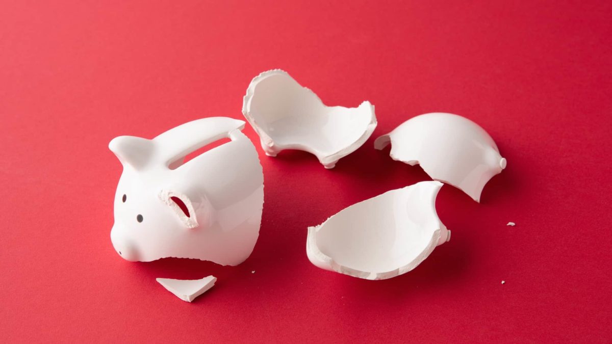NAB share price Broken white piggy bank on red background