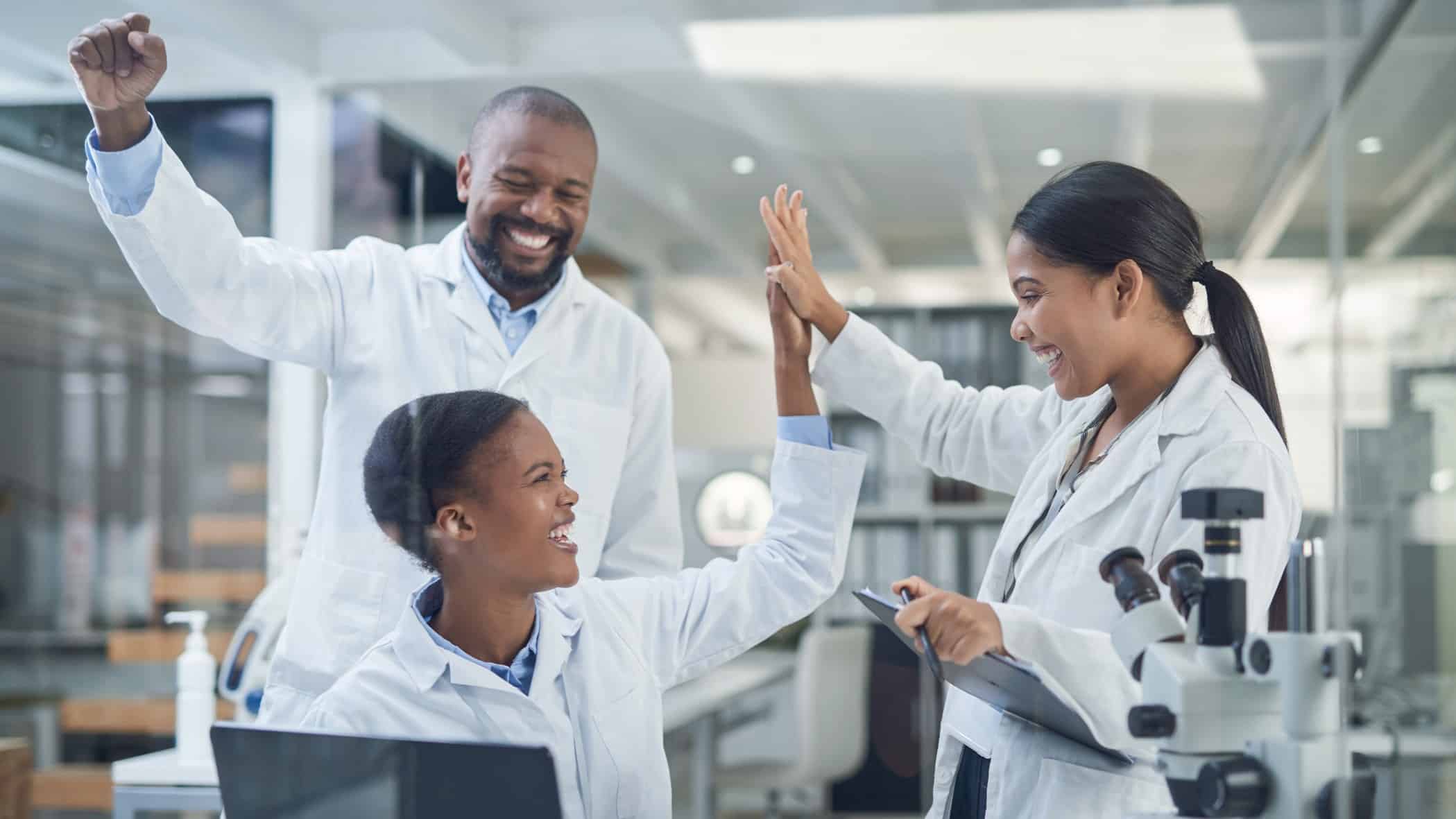 Group of Imugene scientists cheering in the lab after the company received another patent for HER-Vaxx