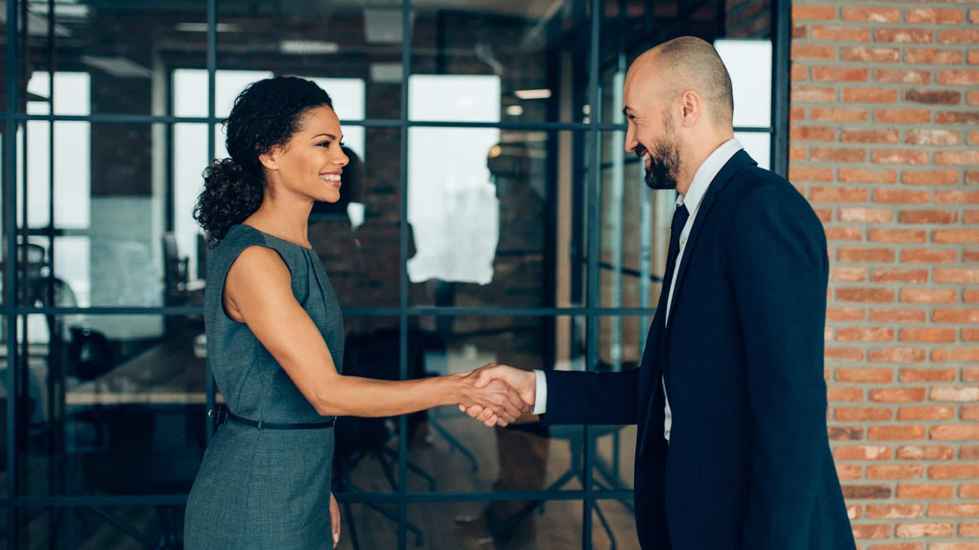Man and woman shake hands on business deal