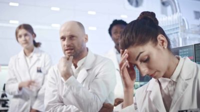 Scientists in white coats look disappointed as the Starpharma share price falls today