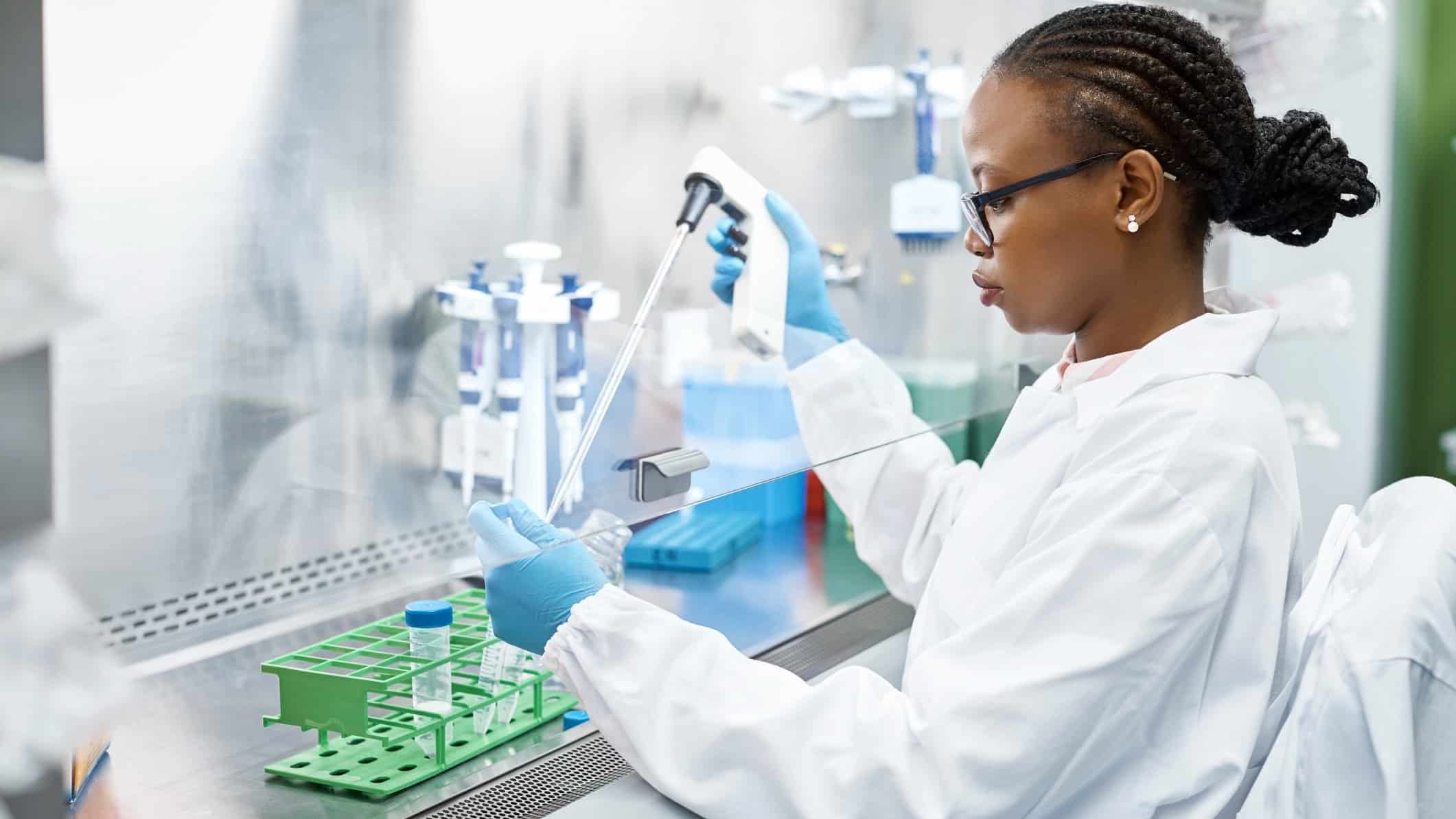 Lab technician analyses a sample in a laboratory for a clinical trial