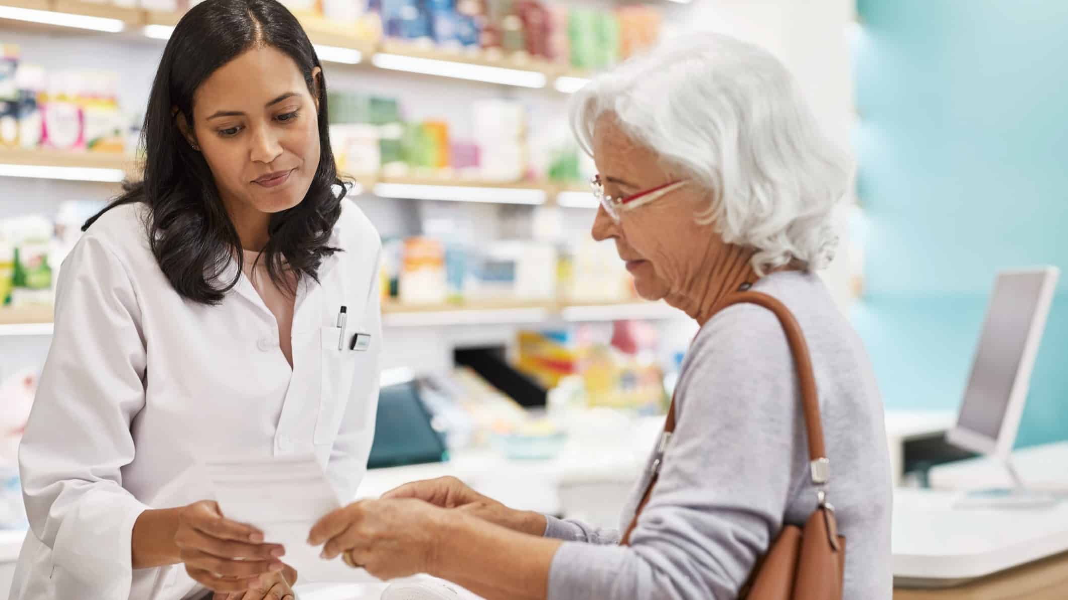 Woman serving customer in pharmacy