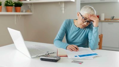 Woman working on laptop making financial decisions
