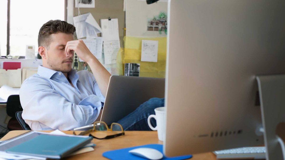 Worried man sitting at computer