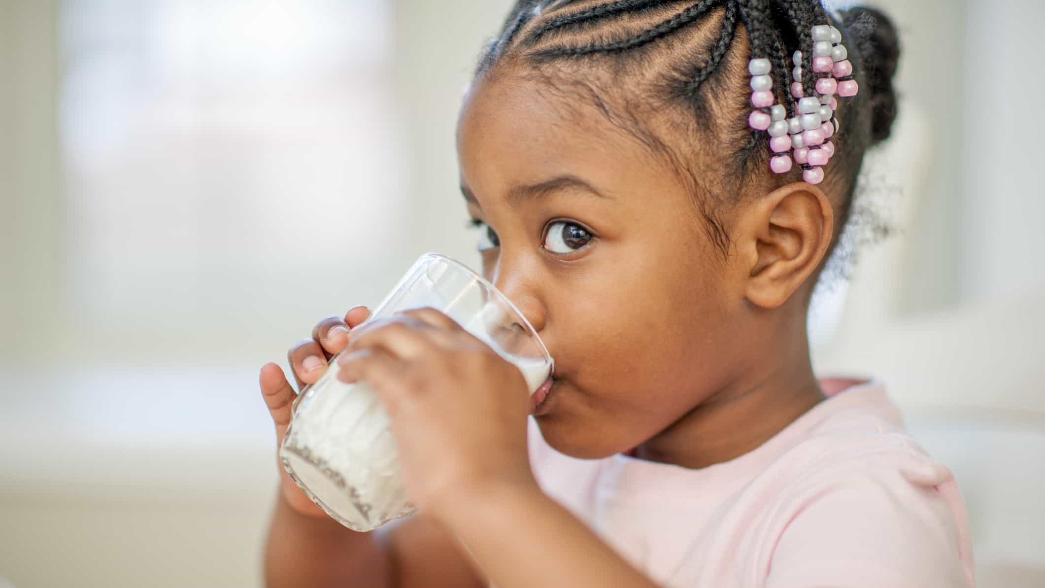 Young girl drinking glass of milk