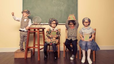 children dressed up in adult clothes at a bingo night with one child winning
