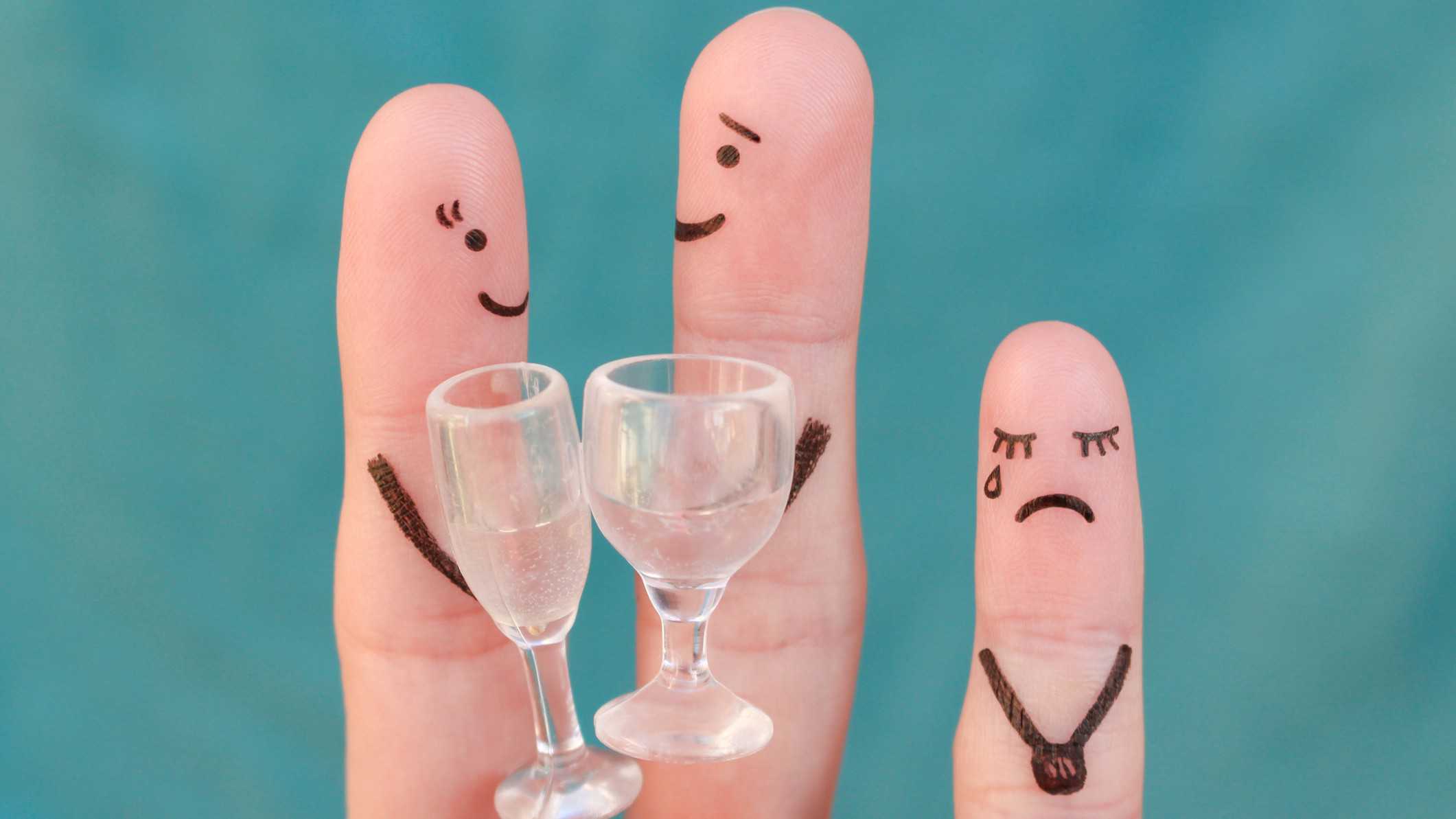 2 fingers with happy faces next to finger drawn with a sad face.