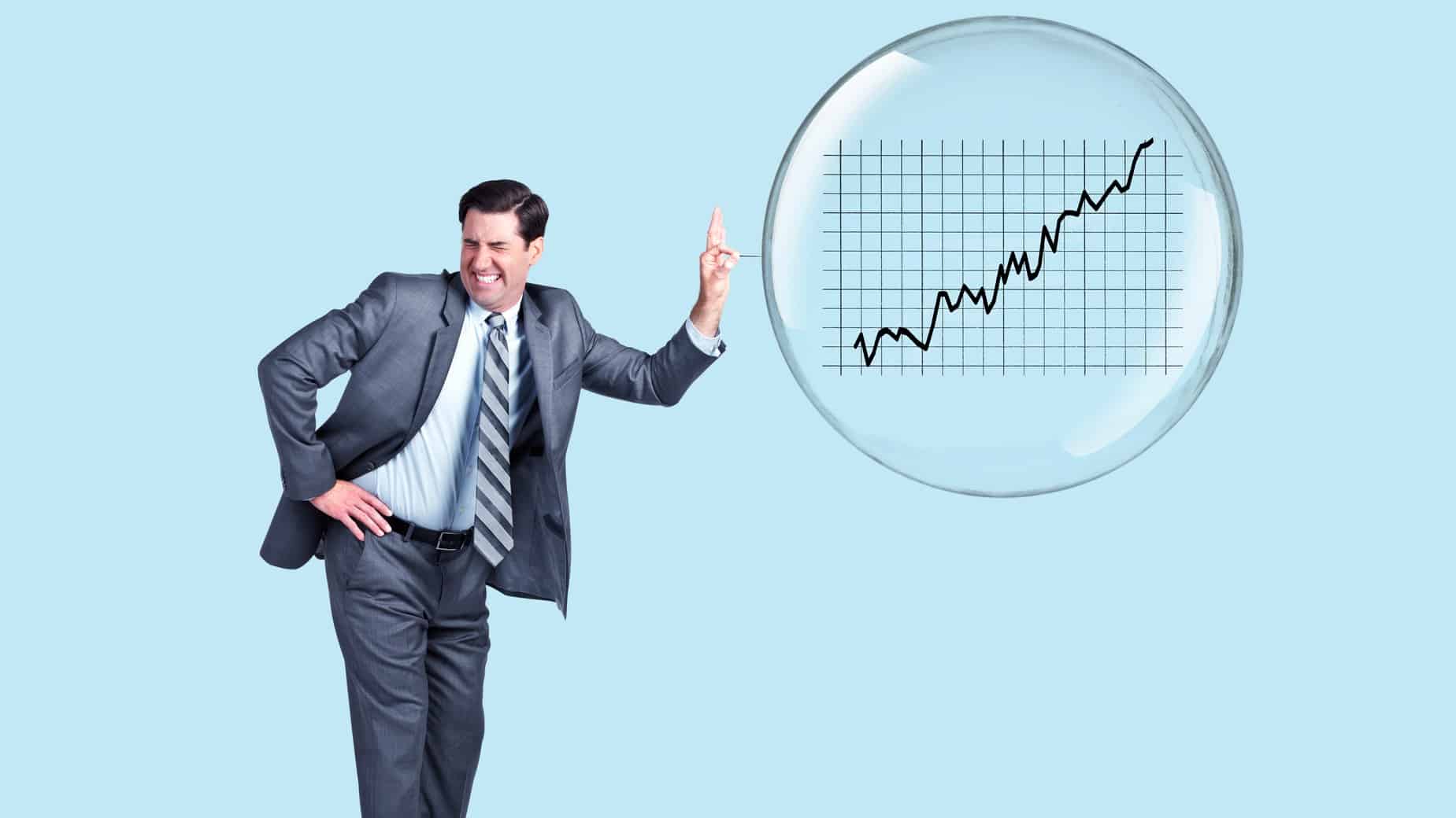 man popping a bubble containing a graph on share market prices
