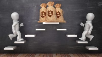 Two figures run up steps to three bitcoin moneybags at the top