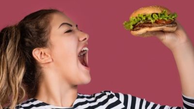 woman about to eat a burger