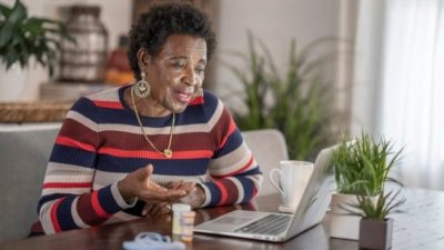 woman chatting online on her macbook