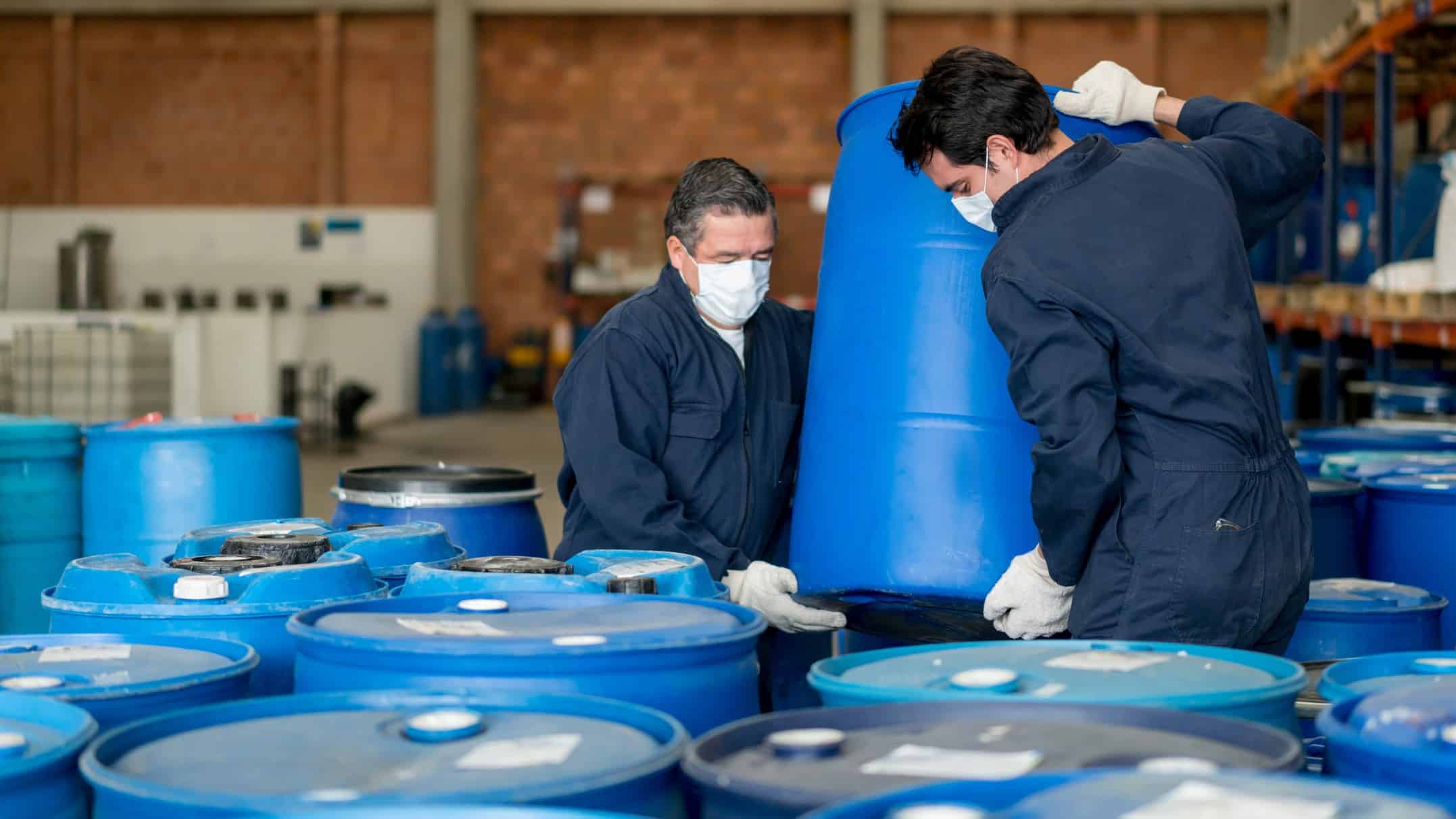 Male DGL employees working with chemical bins symbolising the rising DGL share price today