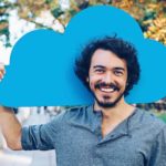Man happy to be holding a blue cloud representing cloud computing.