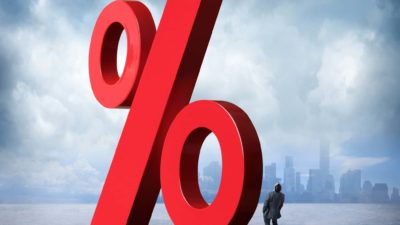 red percentage sign with man looking up which represents high interest rates