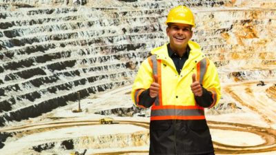 miner standing in a mine with thumbs up