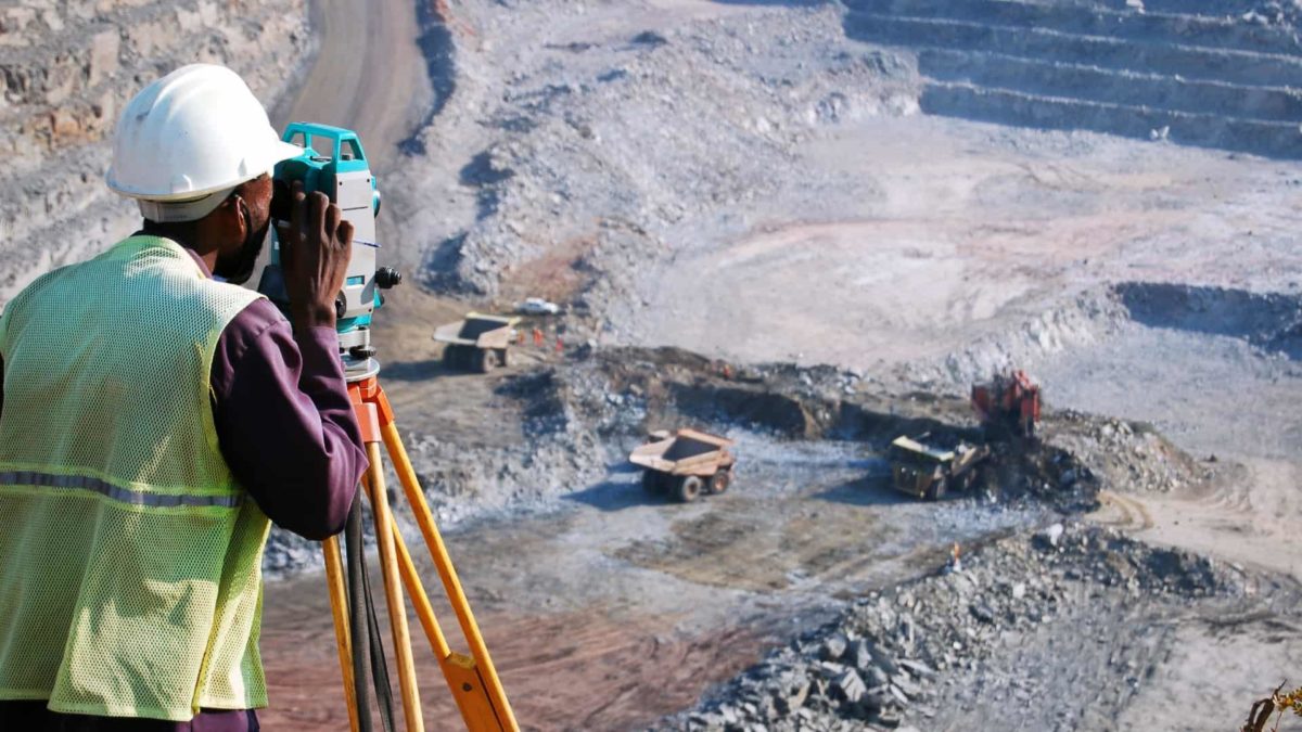 Worker surveying large mine in Africa