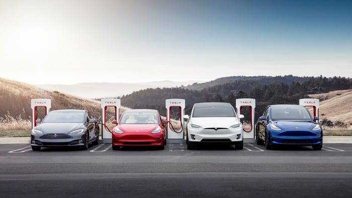 tesla vehicles being charged at a charging station
