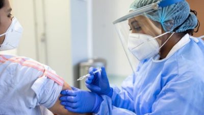 woman receiving covid 19 vaccine