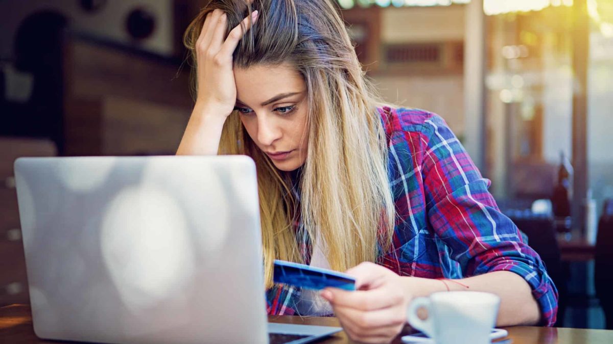 woman head in hands online shopping