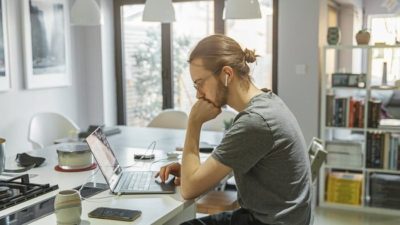 man working from home on his macbook