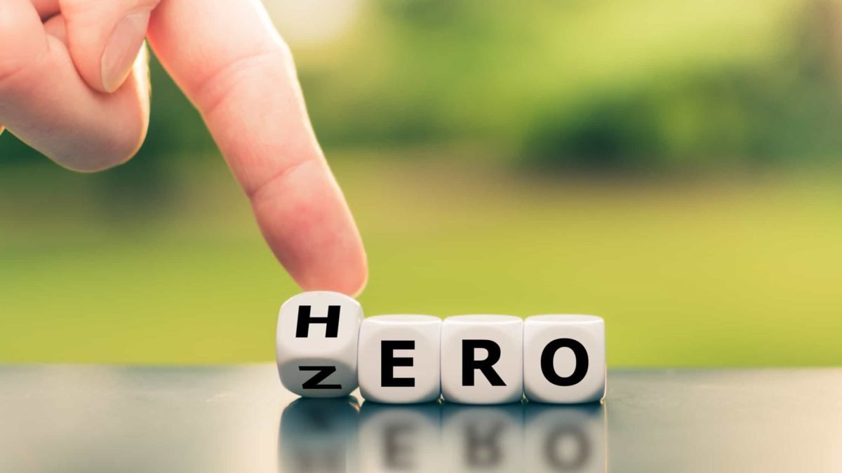 A finger switches the letters on some blocks between zero and hero