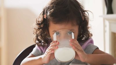 Child drinking milk out of glass